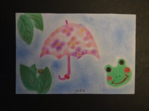 梅雨　傘とカエルのパステル画の写真です。