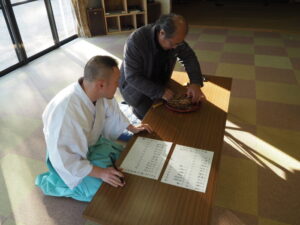 御厨神社・御筒粥祭：葦筒を開き入り具合を確認する写真です。